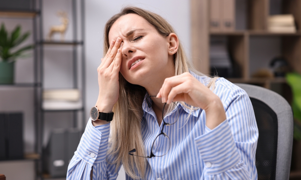 Doctor consulting middle-aged woman about chronic fatigue and health evaluation