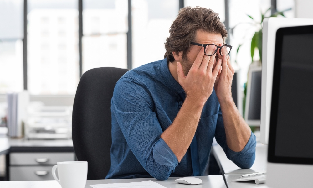 Adult experiencing fatigue and daytime sleepiness while working